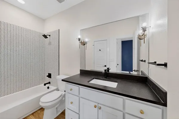 a bathroom with a double vanity sink toilet and shower