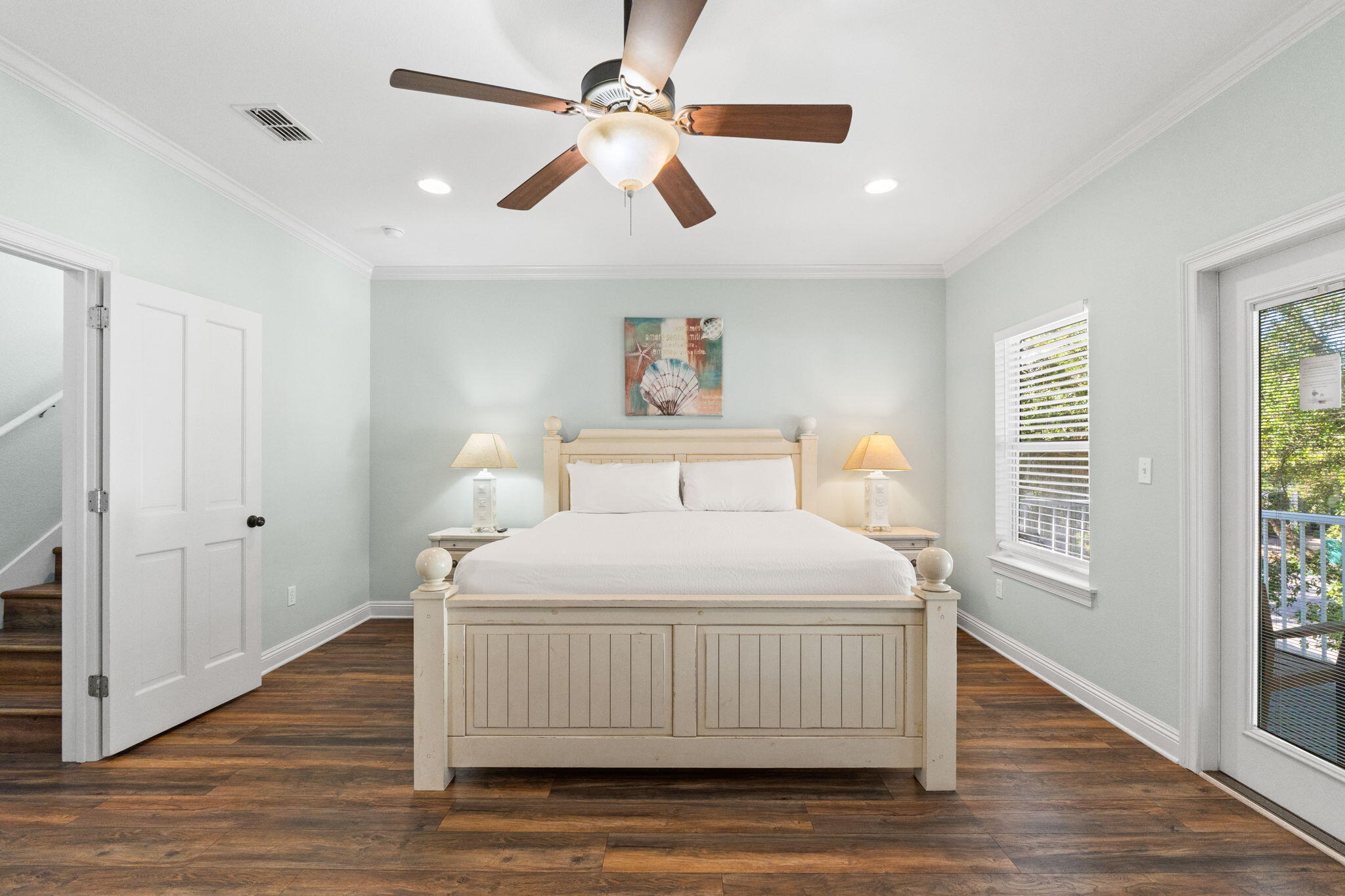 209 Grand Key Loop East Destin, FL 32541 - Photo 18 of 59 a bedroom with a bed and wooden floor