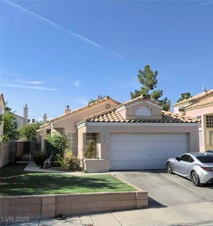 Mediterranean / spanish house featuring driveway, a garage, and stucco siding