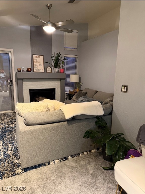 881 Brass Ring Road Las Vegas, NV 89123 - Photo 3 of 13 Living area with a fireplace, a ceiling fan, and light carpet