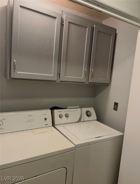 881 Brass Ring Road Las Vegas, NV 89123 - Photo 10 of 13 Laundry area with a textured wall, washing machine and dryer, and cabinet space