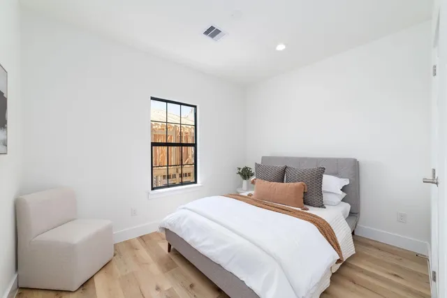 a bedroom with a bed and a couch