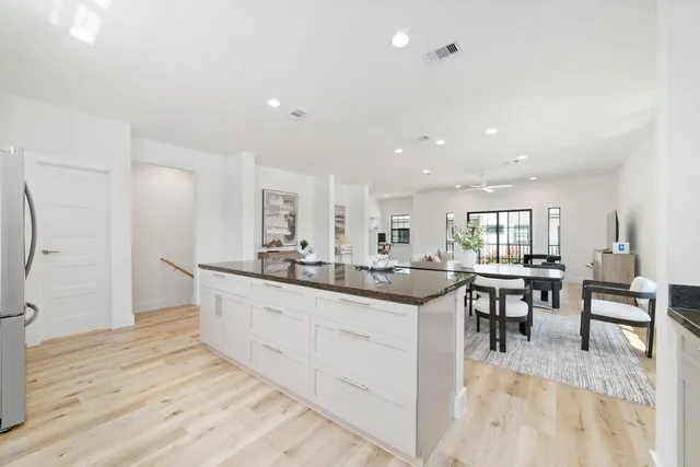 a kitchen with center island table and chairs