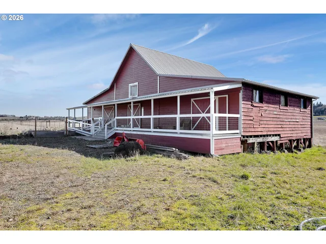 a view of a house with wooden deck and a yard