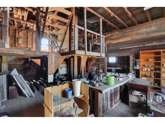 a kitchen view of a living room filled with furniture and a fireplace