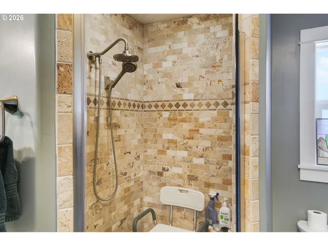 a bedroom with a bed and a view of living room