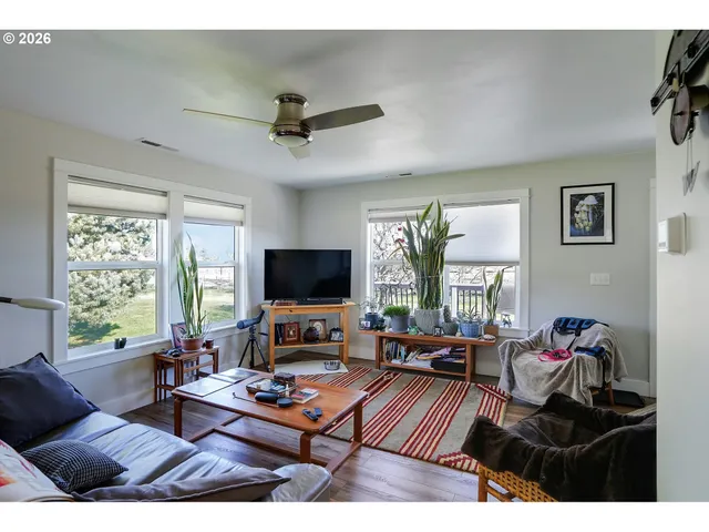 a living room with furniture fireplace and flat screen tv