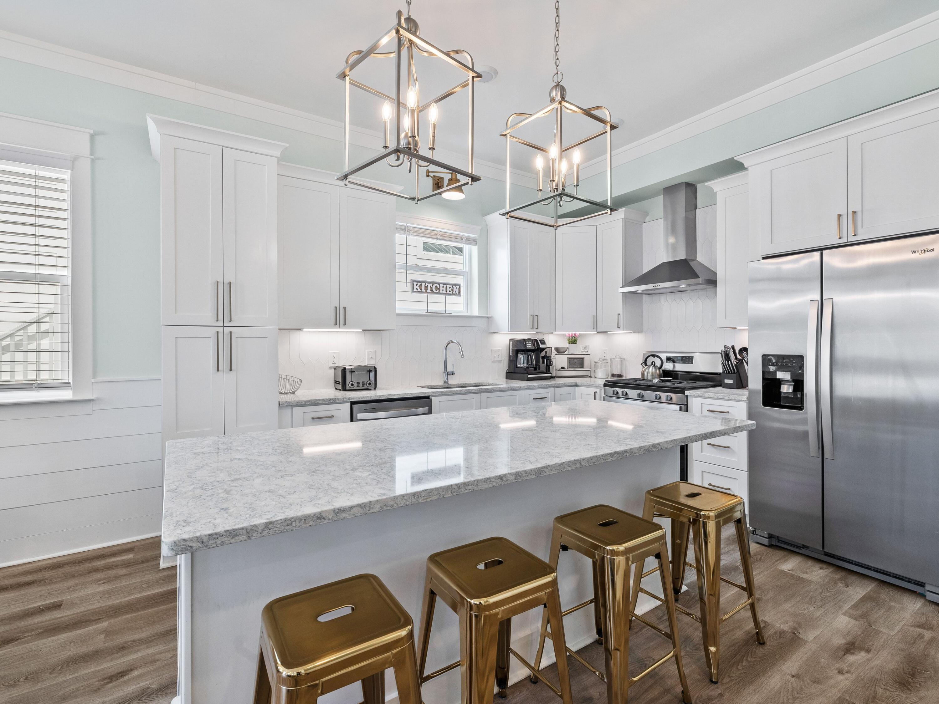 30 Serene Way Santa Rosa Beach, FL 32459 - Photo 3 of 34 a kitchen with stainless steel appliances granite countertop a sink a center island and cabinets