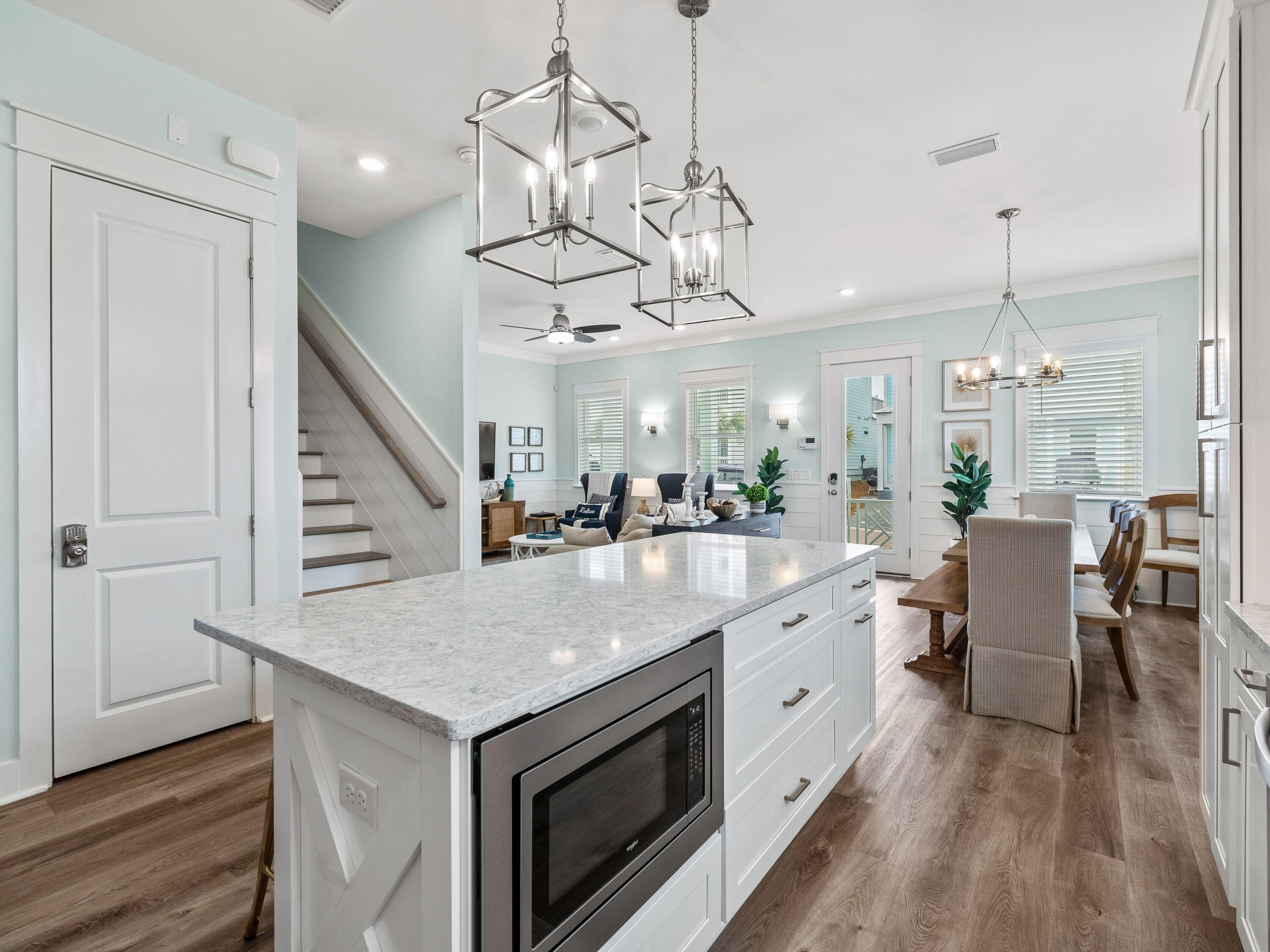30 Serene Way Santa Rosa Beach, FL 32459 - Photo 5 of 34 a large white kitchen with a chandelier