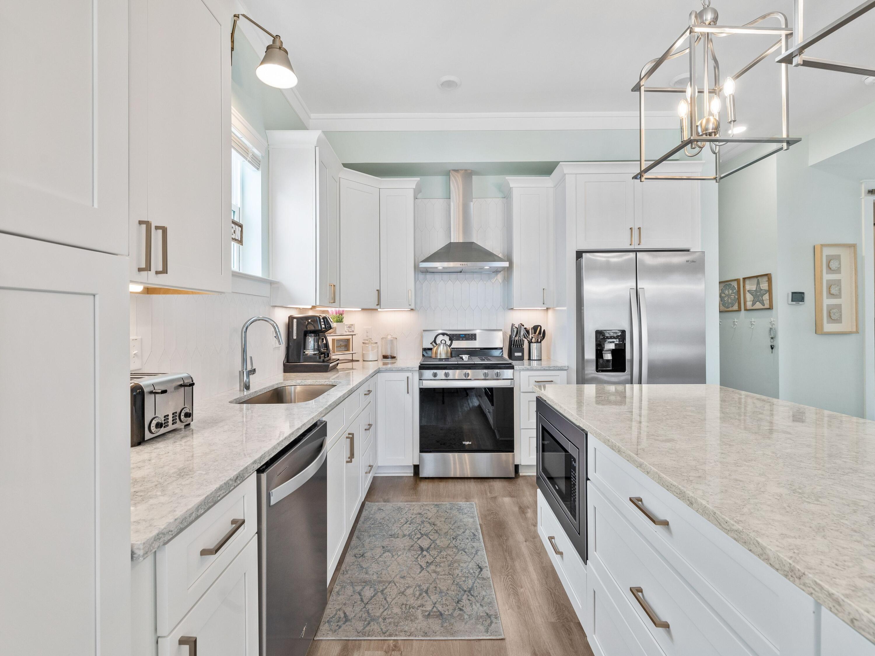 30 Serene Way Santa Rosa Beach, FL 32459 - Photo 6 of 34 a large kitchen with stainless steel appliances granite countertop a sink refrigerator and cabinets