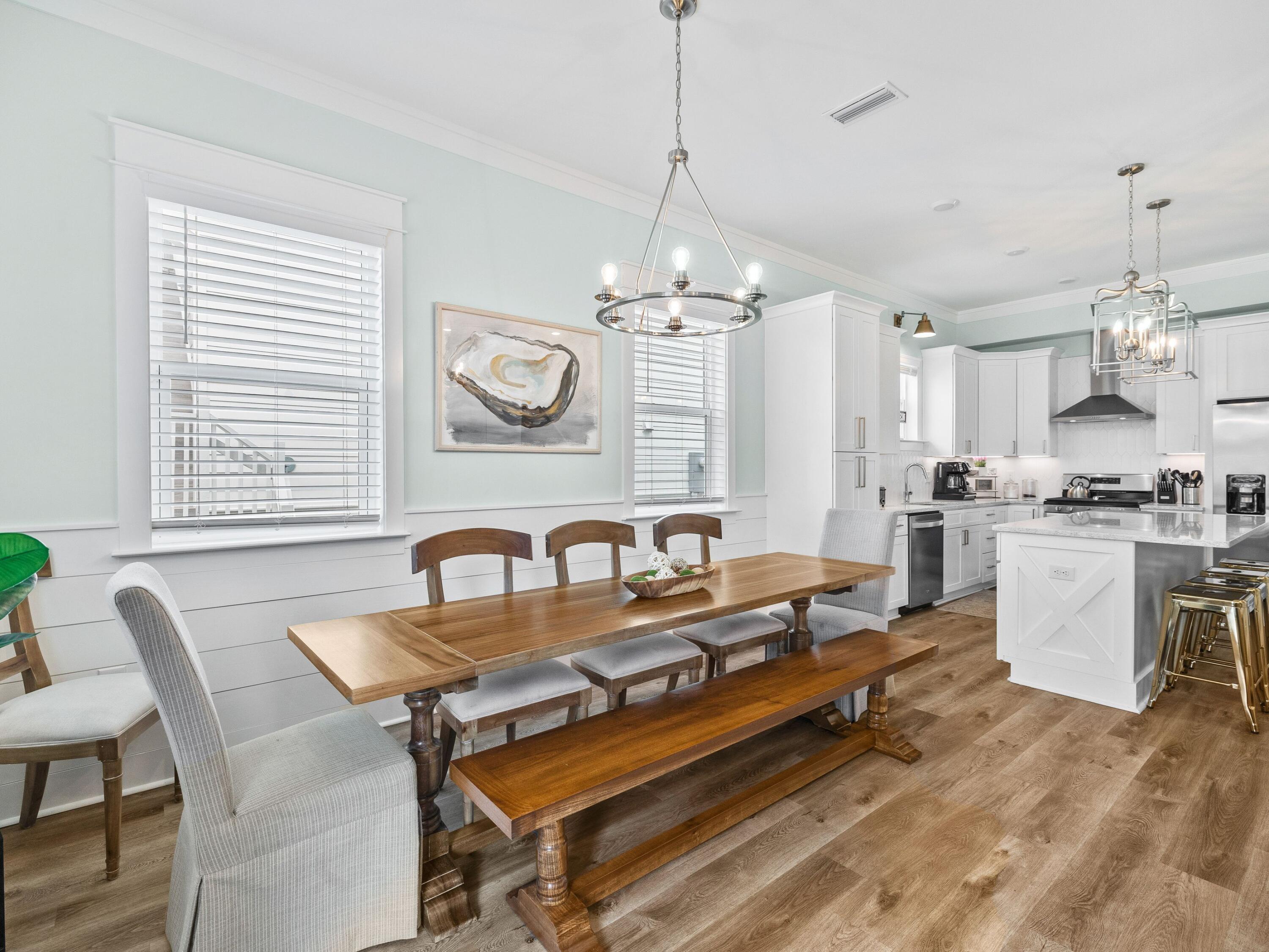 30 Serene Way Santa Rosa Beach, FL 32459 - Photo 7 of 34 a dining room with wooden floor a chandelier a wooden table and chairs