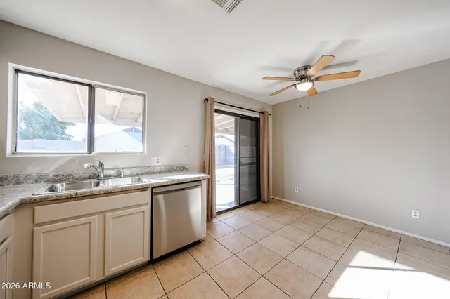 a kitchen with a sink cabinets and window