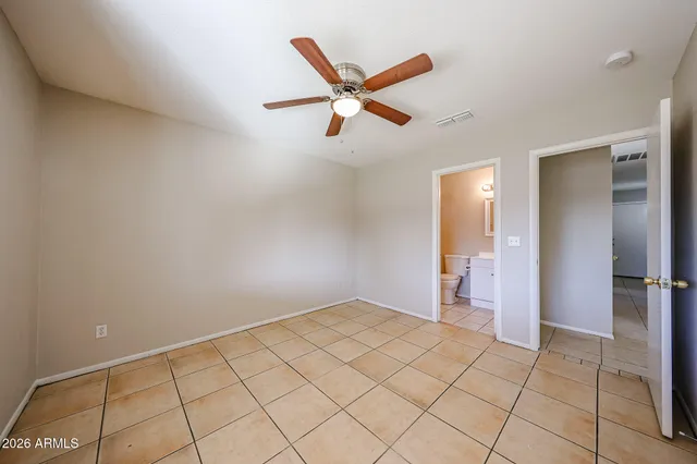 a view of a livingroom with a ceiling fan and wooden floor