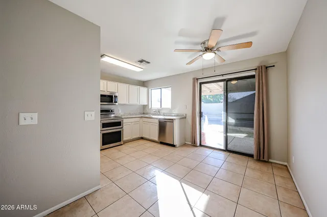 a kitchen with a cabinets a sink and appliances