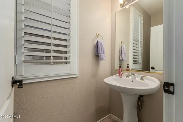 a spacious bathroom with a double vanity sink large mirror and a bathtub