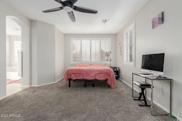 an empty room with windows and a flat screen tv