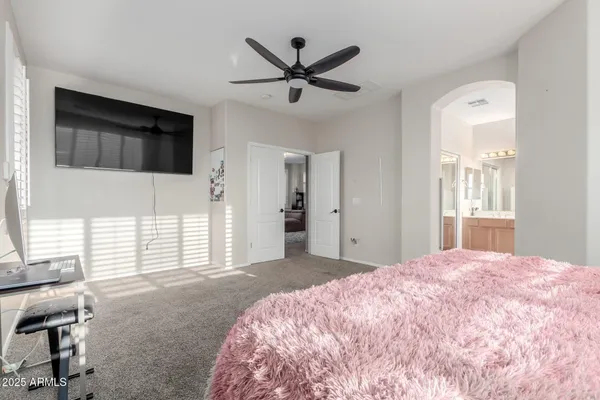 a view of a livingroom with workspace and a flat screen tv