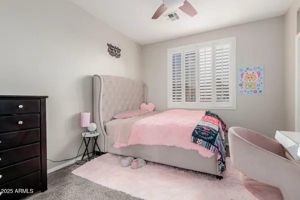 a bedroom with a bed and flat screen tv