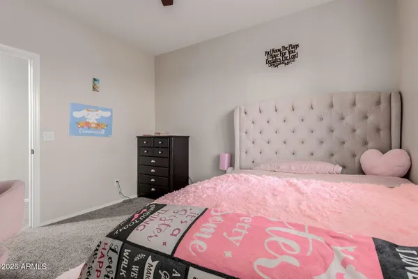 a bedroom with a bed and a flat tv screen