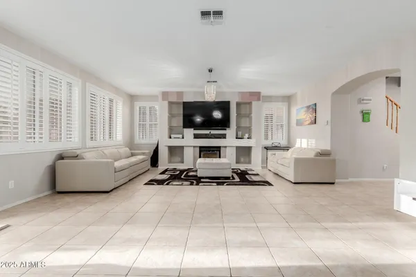 a view of a dining room with furniture and chandelier
