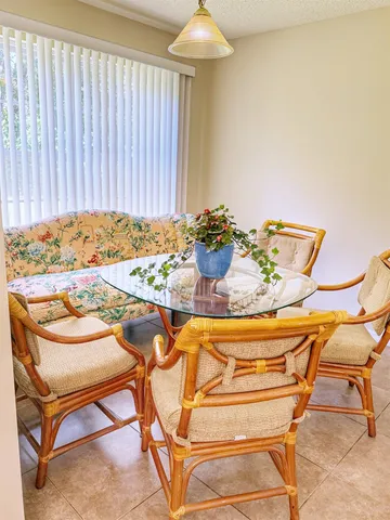 a view of a dining room with furniture and a chandelier