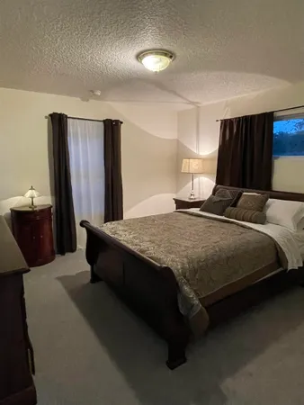 a bedroom with a bed and dresser