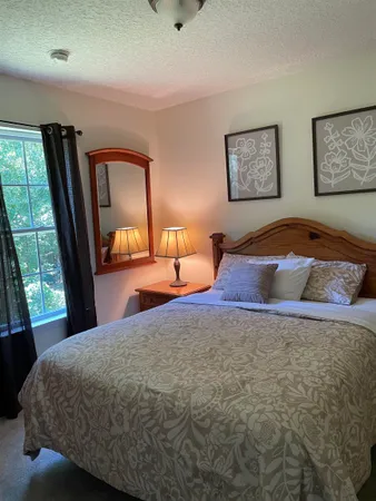 a bedroom with a bed and window