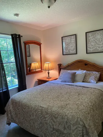 a bedroom with a bed and window