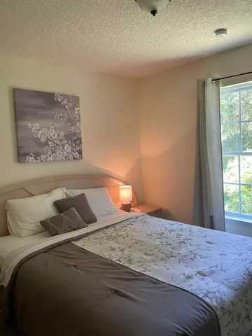 a bedroom with a bed and a window