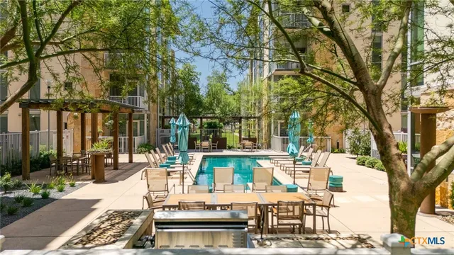 a view of a patio with couches table and chairs and potted plants