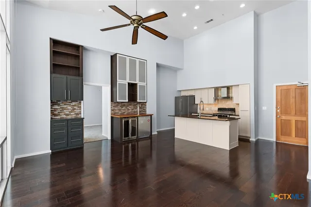 a kitchen with a refrigerator and a stove top oven