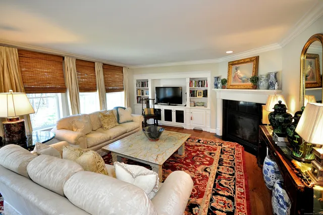 a living room with furniture flat screen tv and a fireplace