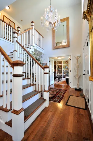 a view of an entryway with wooden floor and a front door