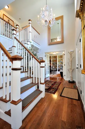 a view of an entryway with wooden floor and a front door