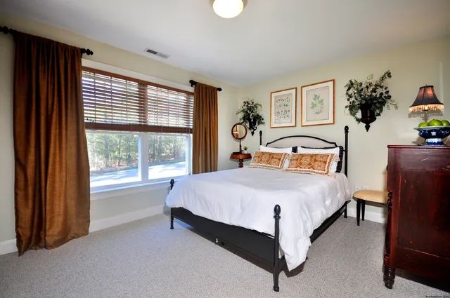 a bedroom with a large bed and a window