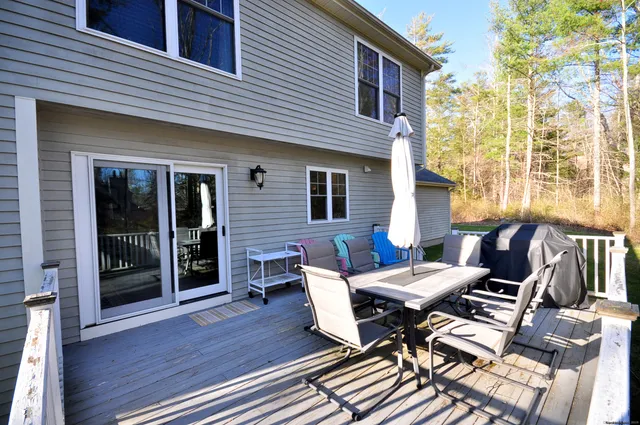 a view of a patio with table and chairs and wooden floor