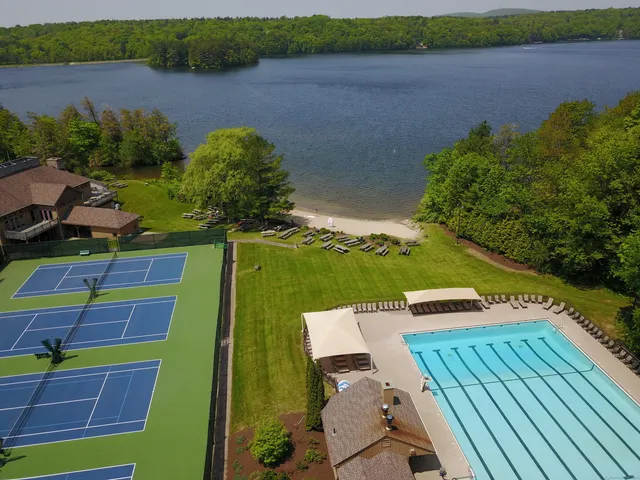 an aerial view of a house with a lake view