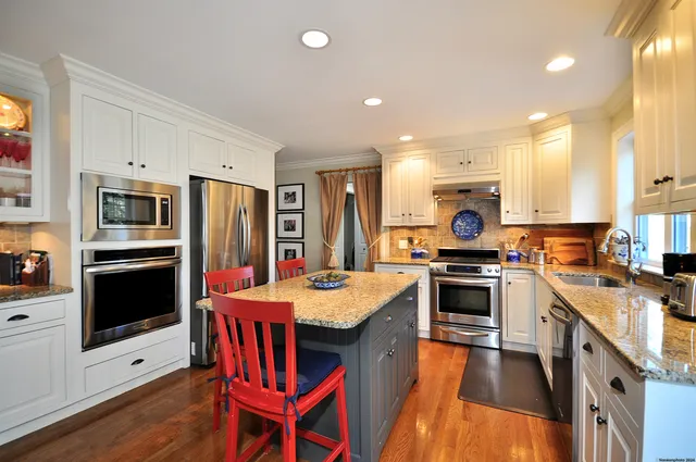 a kitchen with stainless steel appliances granite countertop a stove refrigerator sink and cabinets