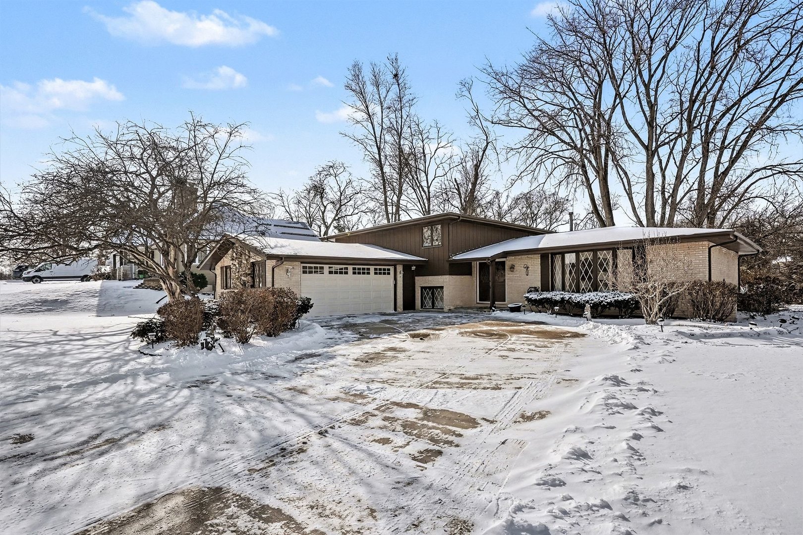 a view of a house with a yard covered in snow