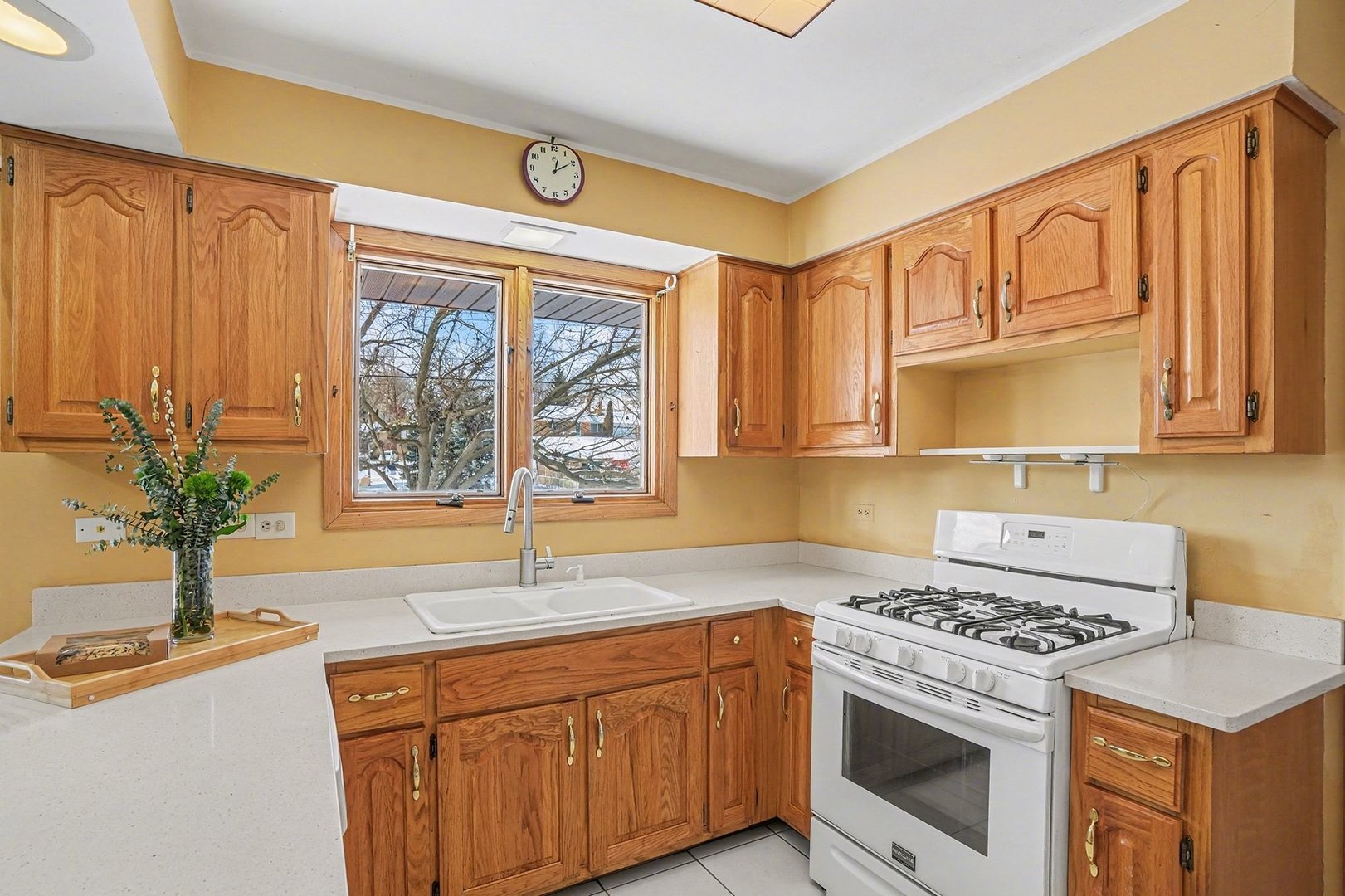 14550 Raneys Lane Orland Park, IL 60462 - Photo 10 of 27 a kitchen with granite countertop a sink a stove and cabinets