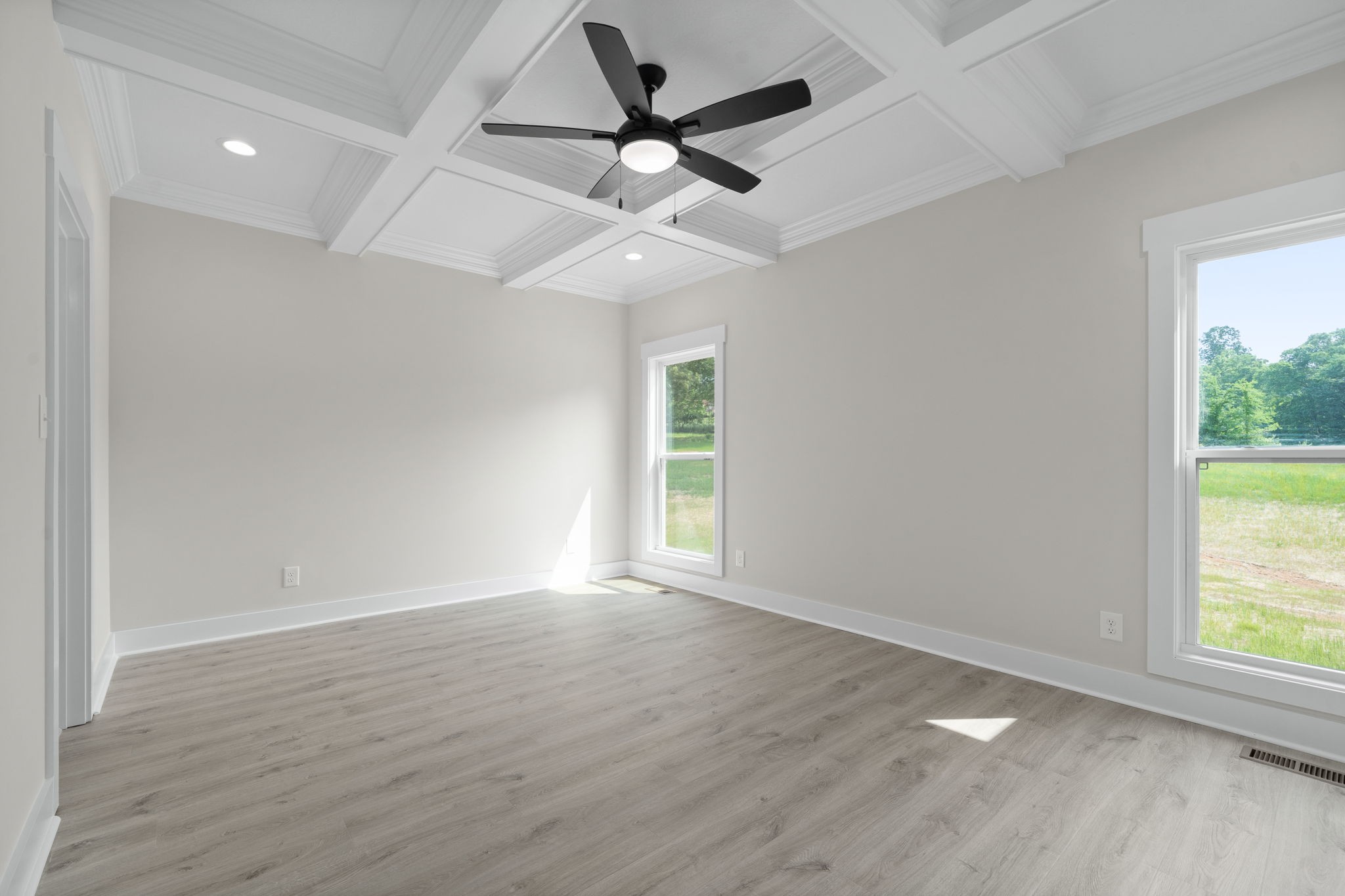 1045 Gratton Road Clarksville, TN 37043 - Photo 17 of 38 an empty room with wooden floor ceiling fan and windows