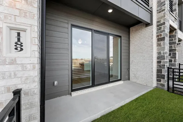 a view of a porch with a door and a yard