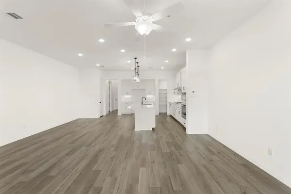a view of a kitchen with a sink and wooden floor
