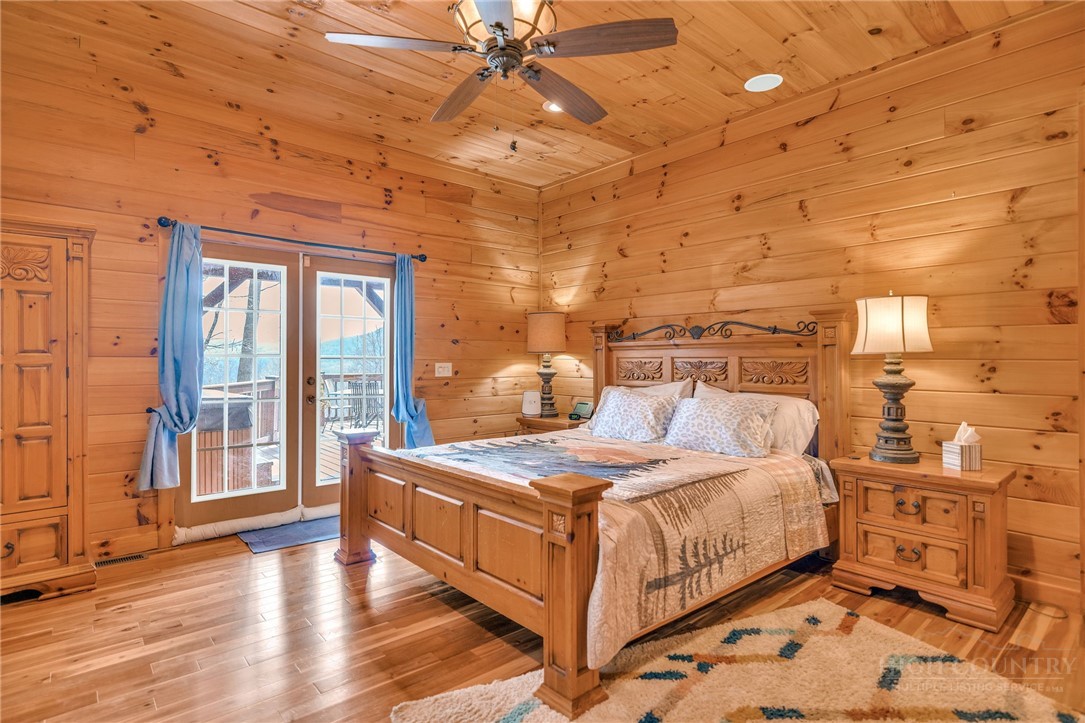 7994 3 Top Road Todd, NC 28684 - Photo 16 of 50 a bedroom with a bed and wooden floor