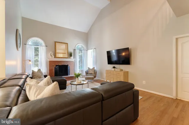 a kitchen with stainless steel appliances granite countertop a refrigerator a sink dishwasher a stove with wooden cabinets and floor