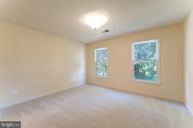 a view of a deck with furniture and garden