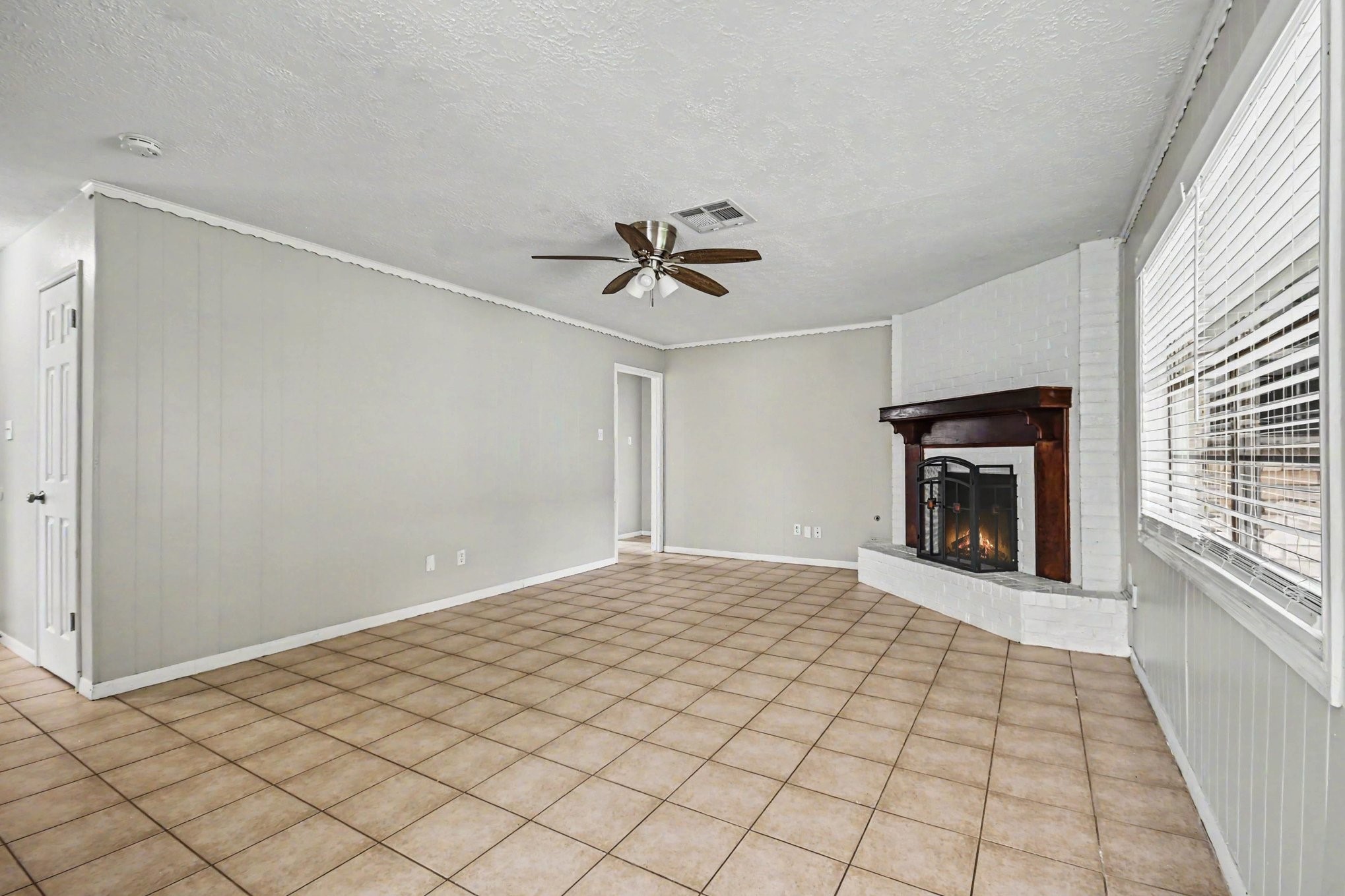 4306 Oneida Street Pasadena, TX 77504 - Photo 5 of 23 a view of an empty room with a fireplace and a window