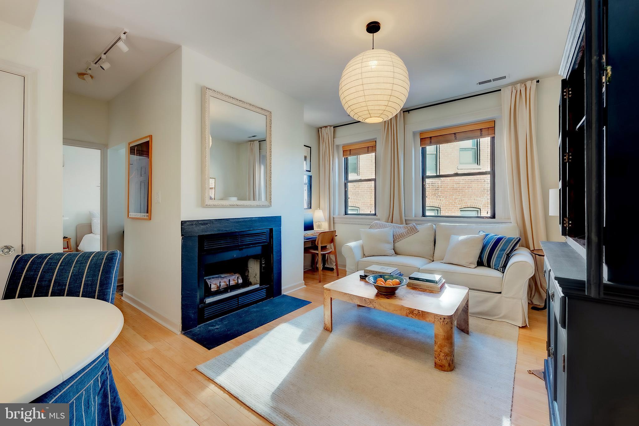 1918 18th Street Northwest, Unit 42 Washington, DC 20009 - Photo 1 of 22 a living room with furniture and a fireplace