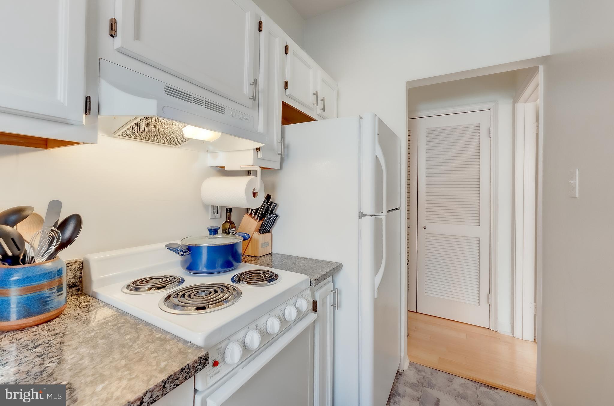 1918 18th Street Northwest, Unit 42 Washington, DC 20009 - Photo 11 of 22 a kitchen with a stove and a refrigerator