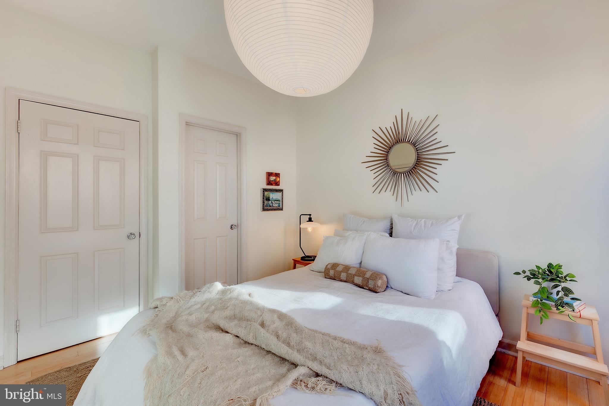 1918 18th Street Northwest, Unit 42 Washington, DC 20009 - Photo 13 of 22 a bedroom with a bed and a chandelier